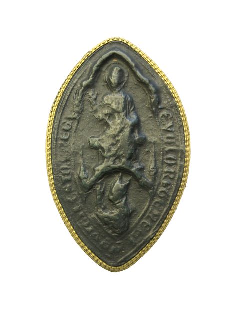 Seal. Cast of a marquise-shaped seal has a seated figure, Christ in Judgement, above a kneeling man. Latin text lines the perimeter. The surface is very worn and details are difficult to make out.